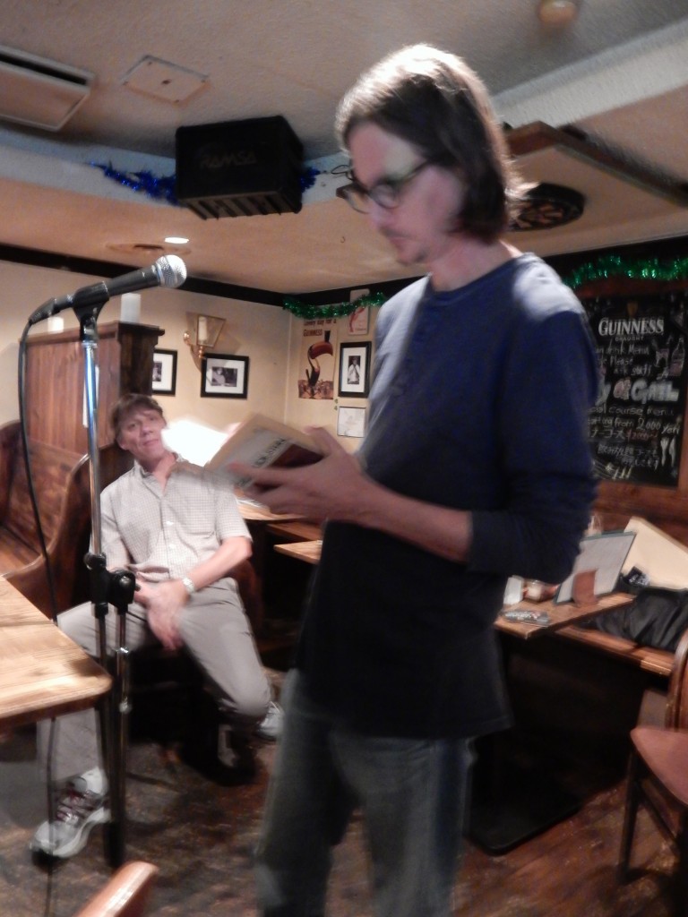 Mark Richardson reads as Mark Scott looks on